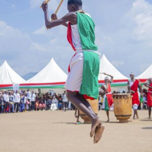 Vibrant traditional dance and drumming performance at an outdoor cultural festival.
